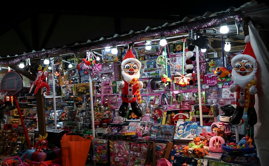Inflatable Santa Claus toys hang among other toys during a Christmas bazaar at a central Athens square, Greece. AP Christmas around the world: Lights, Santa hats and good cheer mark festivities