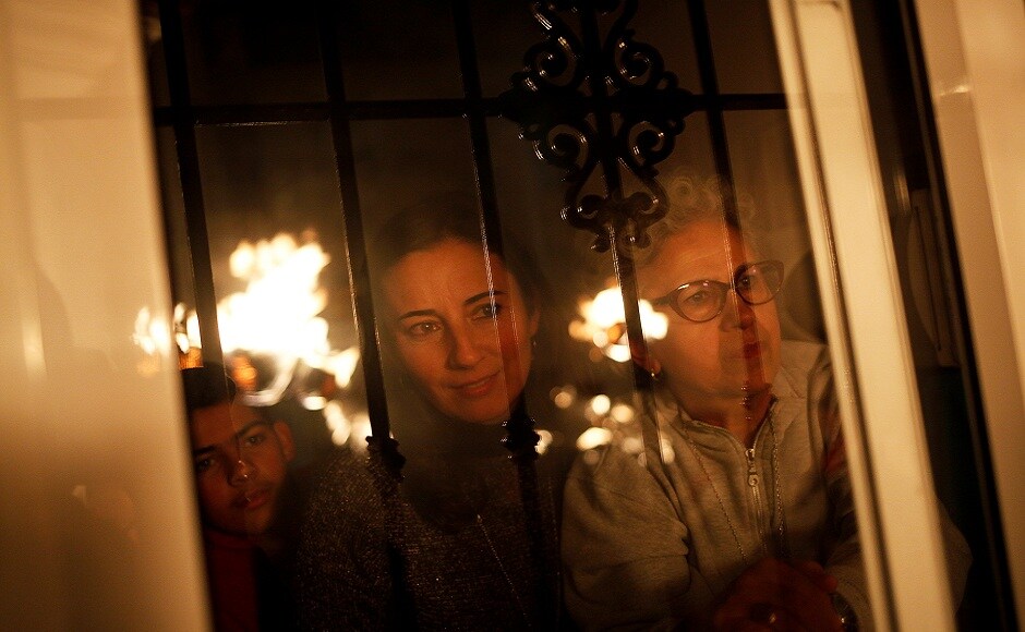 People watch from their house as villagers hold torches to represent light and vision during the Divina Pastora procession, as part of a festival to honour the Virgin of Los Rondeles, on the eve of St. Lucia's Day, in Casarabonela, near Malaga, southern Spain. REUTERS People watch from their house as villagers hold torches to represent light and vision during the Divina Pastora procession, as part of a festival to honour the Virgin of Los Rondeles, on the eve of St. Lucia's Day, in Casarabonela, near Malaga, southern Spain. REUTERS