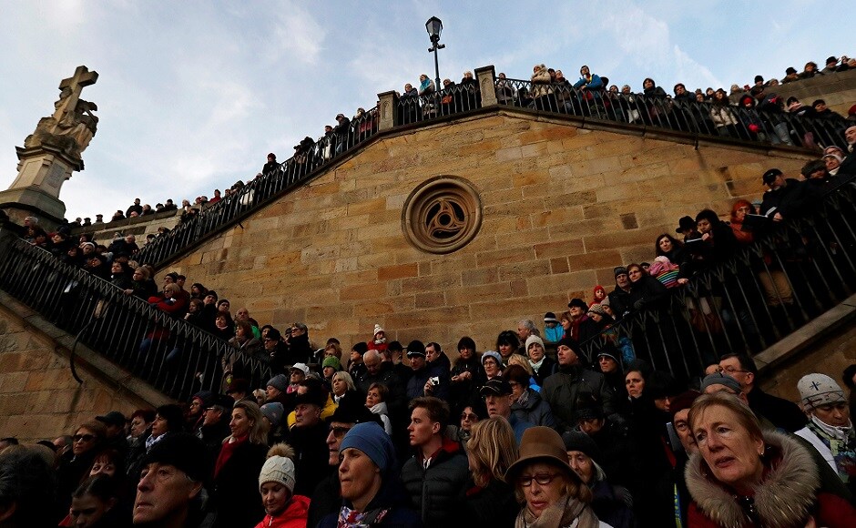 People sing during the performance of 'Czech Christmas Mass' by the Czech composer Jakub Jan Ryba under the medieval Charles Bridge in Prague, Czech Republic. REUTERS Christmas around the world: Lights, Santa hats and good cheer mark festivities
