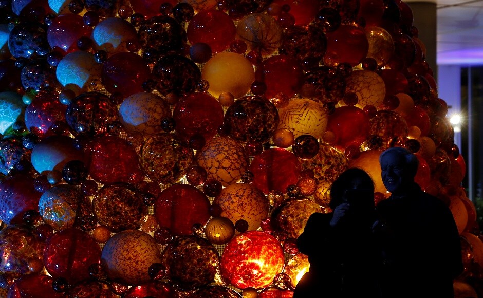 People take a selfie next to a Christmas tree made of glass baubles in Valletta, Malta. REUTERS Christmas around the world: Lights, Santa hats and good cheer mark festivities