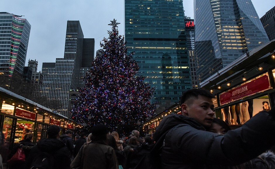 People are seen in front of a Christmas Tree in Bryant Park in New York City, US. REUTERS Christmas around the world: Lights, Santa hats and good cheer mark festivities
