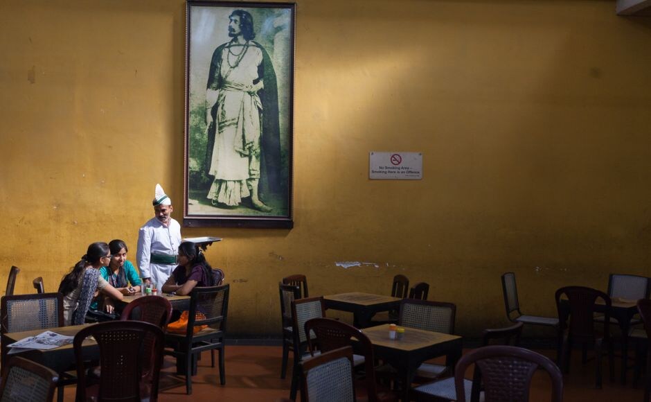 A waiter serves schoolgirls beneath a portrait of Rabindranath Tagore in the Indian Coffee House, Kolkata, 2013. Stuart Freedman/Tasveer The Palaces of Memory: Stuart Freedman's unique perspective on Indian Coffee House