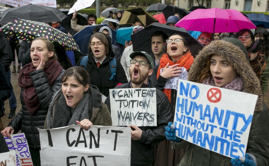 Graduate students around the US are staging campus walk-outs and lobbying Congress in an effort to keep their tuition waivers tax-free. They have the support of their schools in arguing that a provision in the House Republican tax bill could, as graduate student Shawn Rhoads says, "upend the American PhD system." AP Graduate students around the US are staging campus walk-outs and lobbying Congress in an effort to keep their tuition waivers tax-free. They have the support of their schools in arguing that a provision in the House Republican tax bill could, as graduate student Shawn Rhoads says, "upend the American PhD system." AP
