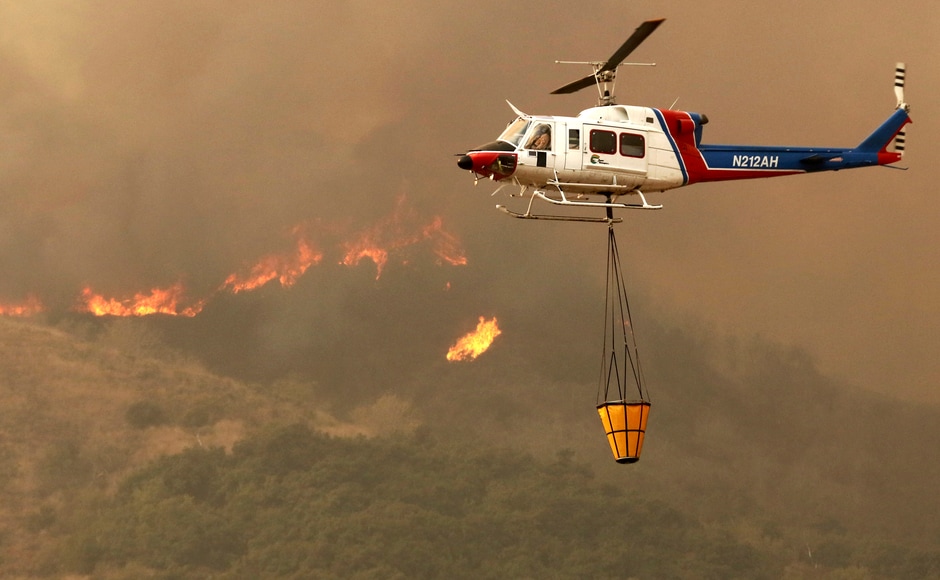 The water-dropping planes and helicopters essential were used to tame and contain the fire. AP The water-dropping planes and helicopters essential were used to tame and contain the fire. AP