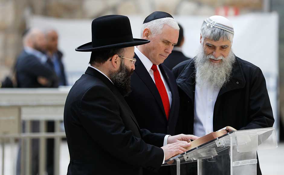 US vice-president Mike Pence visited Jerusalem's Western Wall on Tuesday while Palestinians held a general strike after denouncing his fervently pro-Israel speech the previous day as "messianic". Pence looks at a book together with Western Wall Heritage Foundation Director General Mordechai Elias (Right) and Rabbi of the Western Wall Shmuel Rabinovitch. AP US vice-president Mike Pence visited Jerusalem's Western Wall on Tuesday while Palestinians held a general strike after denouncing his fervently pro-Israel speech the previous day as "messianic". Pence looks at a book together with Western Wall Heritage Foundation Director General Mordechai Elias (Right) and Rabbi of the Western Wall Shmuel Rabinovitch. AP