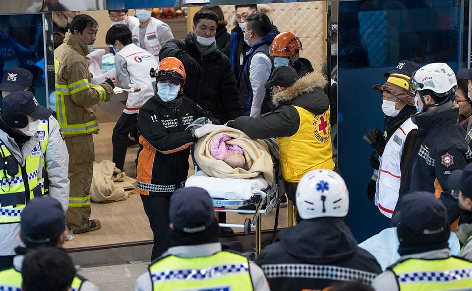 Survivors were brought out wrapped in blankets, and firefighters picked their way through the blackened shell of the building after the blaze was extinguished. AP Survivors were brought out wrapped in blankets, and firefighters picked their way through the blackened shell of the building after the blaze was extinguished. AP