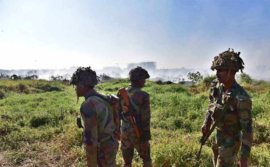 Army jawans stand guard near the Bellandur lake, after it caught fire, on Saturday. The locals had noticed huge clouds of smoke billowing from the lake replete with sewage, chemical effluents and construction debris. PTI Army jawans stand guard near the Bellandur lake, after it caught fire, on Saturday. The locals had noticed huge clouds of smoke billowing from the lake replete with sewage, chemical effluents and construction debris. PTI