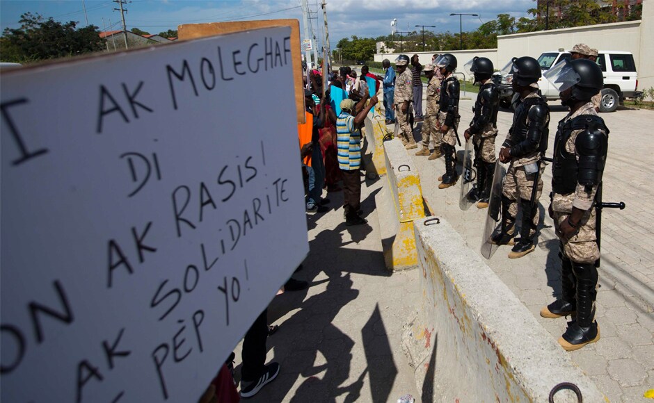 National police officers stand guard in front of the US embassy during a rally against Trump in Haiti. The US president last week was quoted as calling African nations and Haiti