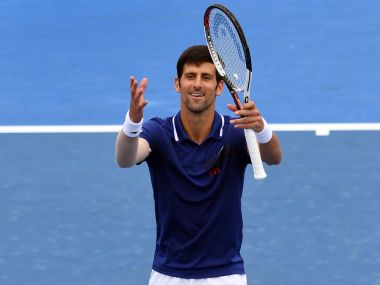 Novak Djokovic waves to the crowds after winning his match against Dominic Thiem. AFP