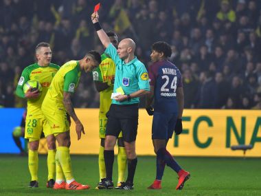 Nantes defender Diego Carlos (centre) receives a red card during the match against Paris Saint-Germain. AFP