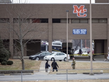 Authorities investigate the scene after a deadly shooting at Marshall County High School in Benton, Ky., Tuesday, Jan. 23, 2018. (Ryan Hermens/The Paducah Sun via AP)