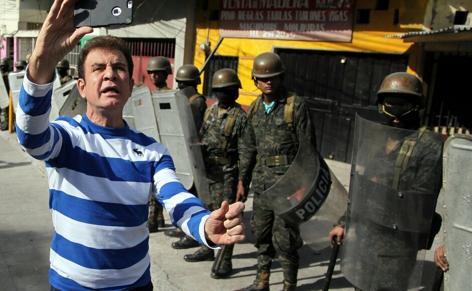 Opposition presidential candidate Salvador Nasralla made a livestream broadcast along with supporters during clashes with military police in the Policarpo Paz Garcia neighborhood of Tegucigalpa in Honduras on Saturday. AP One killed in Honduras protests against re-election of President Juan Orlando Hernandez