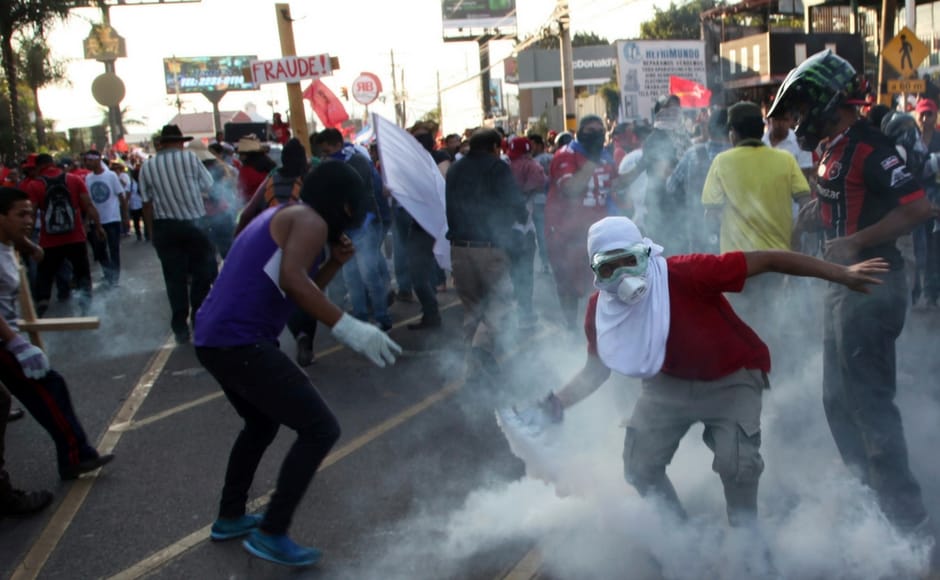 Protests turned violent with security forces firing tear gas and some marchers breaking windows and setting fires. AP Protests against Honduran president Juan Orlando Hernandez's re-election turn violent