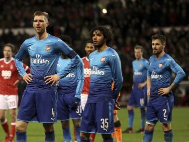 Arsenal's Per Mertesacker and Mohamed Elneny look dejected during the FA Cup match against Nottingham Forest. AP