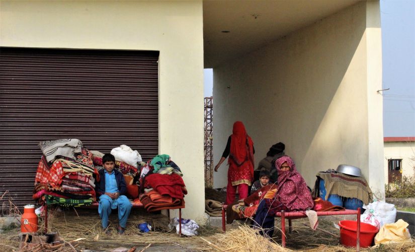 Class VI student Mohammad Rafiq is sitting on the cart parked along a roadside pavement in Chakrohi. Image by Sameer Yasir