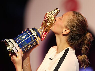 Petra Kvitova of the Czech Republic poses with her trophy on the podium after winning the final of the women's singles at the Qatar Open tennis competition in Doha, on February 18, 2018. Petra Kvitova beat Garbine Muguruza of Spain 3-6, 6-3, 6-4. / AFP PHOTO / KARIM JAAFAR