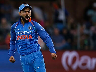 India captain Virat Kohli (R) celebrates after bowler Hardik Pandya (unseen) dismissed South Africa batsman JP Duminy (unseen) during the fifth One Day International cricket match between South Africa and India at Saint George Park, in Port Elizabeth, on February 13, 2018. / AFP PHOTO / MARCO LONGARI