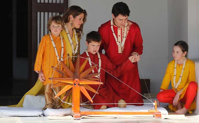 After paying tributes to Mahatma Gandhi, the Canadian prime minister tried his hand at the spinning wheel. AP After paying tributes to Mahatma Gandhi, the Canadian prime minister tried his hand at the spinning wheel. AP