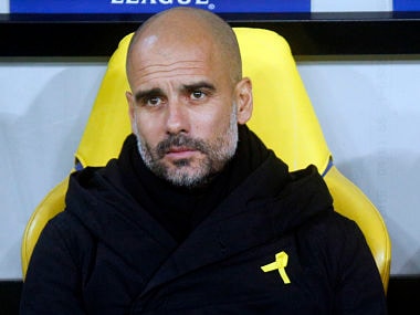 FILE - In this Wednesday, Dec. 6, 2017 file photo, Manchester City coach Josep Guardiola looks on during their Champions League group F soccer match against Shakhtar Donetsk at the Metalist Stadium in Kharkiv, Ukraine. The English Football Association on Friday, Feb. 23, 2018 has charged Manchester City manager Pep Guardiola for promoting a political message by wearing a ribbon to support of imprisoned and ousted pro-independence Catalan politicians. Guardiola was born in Catalonia and is revered in the region because of his links with Barcelona's soccer team, as both a player and coach.(AP Photo/Efrem Lukatsky, file)