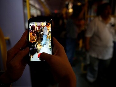 A passenger plays the augmented reality mobile game