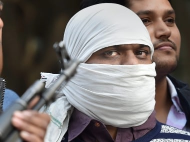 New Delhi: Ariz Khan alias Junaid, one of the most wanted Indian Mujahideen terrorist being taken to a court by Delhi Police Special Cell after his arrest, in New Delhi on Wednesday. PTI Photo by Manvender Vashist (PTI2_14_2018_000121B)