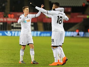 Swansea City's Jordan Ayew celebrates scoring with teammates. Image courtesy: Twitter @SwansOfficial