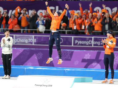 Ireen Wust of the Netherlands celebrates on the podium after winning gold in womens 1,500m. Reuters 