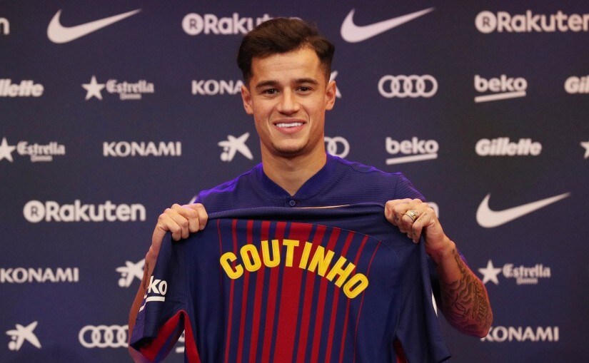 Barcelona's new signing Philippe Coutinho poses with the club shirt. Reuters