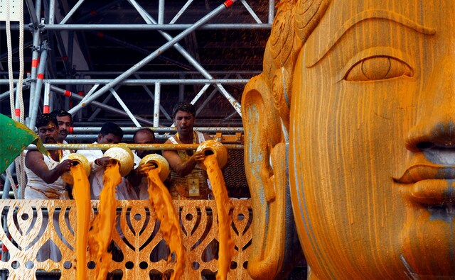 The statue was bathed by devotees from 'attanige' (huge scaffolding) erected for the purpose, with libations such as water, coconut water, sugarcane juice, milk, rice flour, turmeric paste, herbal concoction, kalkachurna, sandal paste, ashtagandha, saffron, gold and silver flowers, as also precious stones, amidst the chanting of hymns. Reuters The statue was bathed by devotees from 'attanige' (huge scaffolding) erected for the purpose, with libations such as water, coconut water, sugarcane juice, milk, rice flour, turmeric paste, herbal concoction, kalkachurna, sandal paste, ashtagandha, saffron, gold and silver flowers, as also precious stones, amidst the chanting of hymns. Reuters