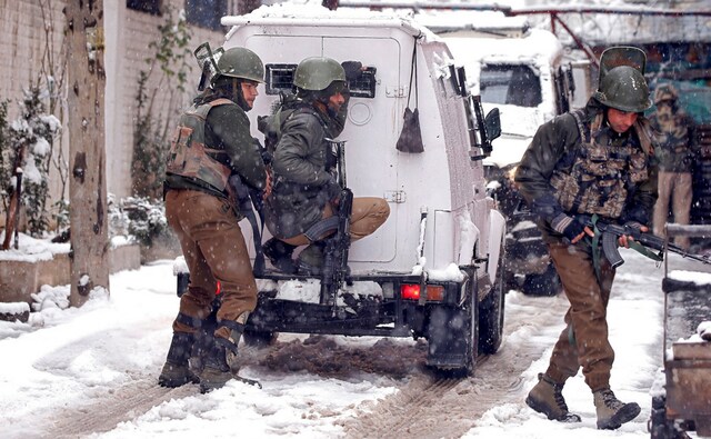 At Karanagar, policemen took their positions near the site of encounter with suspected militants amid snowfall in Srinagar. Reuters At Karanagar, policemen took their positions near the site of encounter with suspected militants amid snowfall in Srinagar. Reuters