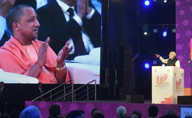 Narendra Modi lauded the chief minister Yogi Adityanath and his government for reducing red tapism and also rolling out red carpet for investors. Narendra Modi lauded the chief minister Yogi Adityanath and his government for reducing red tapism and also rolling out red carpet for investors.