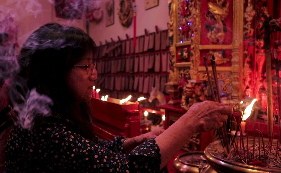 Hundreds of people gathered at the temple on Thursday. They burned incense and prayed to the warrior god Kwan Kung. Firstpost/Sonali Jain Hundreds of people gathered at the temple on Thursday. They burned incense and prayed to the warrior god Kwan Kung. Firstpost/Sonali Jain