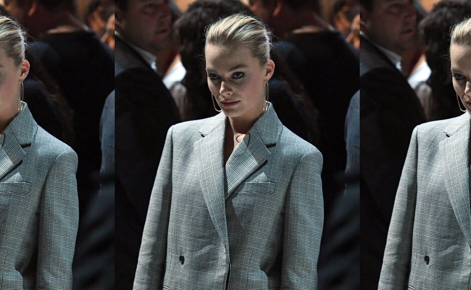 Margot Robbie ditched the dress and went for a sleek grey suit at the Calvin Klein show at New York Fashion Week. Image from AFP/Angela Weiss Margot Robbie ditched the dress and went for a sleek grey suit at the Calvin Klein show at New York Fashion Week. Image from AFP/Angela Weiss