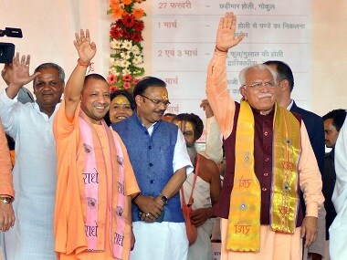 Haryana chief minister Manohar Lal Khattar and Uttar Pradesh chief minister Yogi Adityanath during Lathmar Holi celebrations. PTI