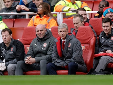 Arsenal French manager Arsene Wenger, center, sits on the bench during the English Premier League soccer match between Arsenal and Watford at the Emirates stadium in London, Sunday, March 11, 2018. (AP Photo/Matt Dunham)