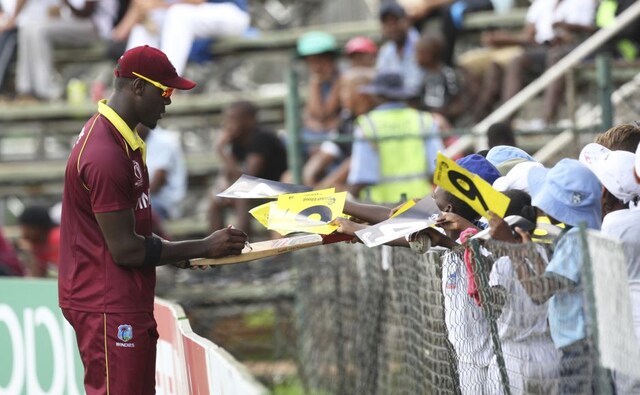 West Indies player Carlos Brathwaite signs autographs for children during the cricket world cup qualifier match against Afghanistan at Harare West Indies player Carlos Brathwaite signs autographs for children during the cricket world cup qualifier match against Afghanistan at Harare