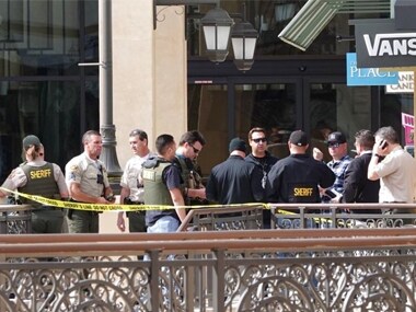 Law enforcement officers work in The Oaks mall in Thousand Oaks, Calif., about 40 miles (64 kilometers) west of Los Angeles on Saturday. AP
