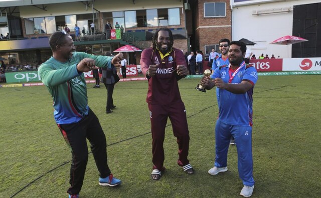 West Indies player Christopher Gayle, centre, dances with Afghanistan batsman Mohammad Shahzad, right, and Afghanistan coach Phill Simmons after their cricket world cup qualifier match at Harare. AP West Indies player Christopher Gayle, centre, dances with Afghanistan batsman Mohammad Shahzad, right, and Afghanistan coach Phill Simmons after their cricket world cup qualifier match at Harare. AP