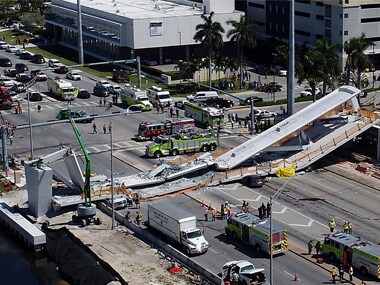 Emergency personnel respond after a brand-new pedestrian bridge collapsed onto a highway at Florida International University in Miami on Thursday. AP