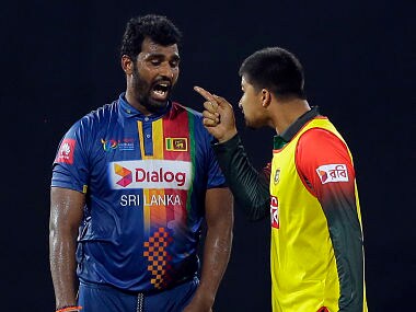 Bangladesh's Nurul Hasan exchanges words with Sri Lanka's skipper Thisara Perera on Friday. AP 