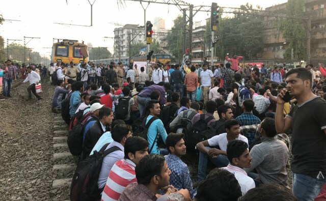Scores of agitating students demanding jobs in railways blocked rail traffic, including suburban services between Matunga and Dadar stations, causing difficulties to lakhs of commuters on Tuesday. Firstpost/Sachin Gokhale Scores of agitating students demanding jobs in railways blocked rail traffic, including suburban services between Matunga and Dadar stations, causing difficulties to lakhs of commuters on Tuesday. Firstpost/Sachin Gokhale
