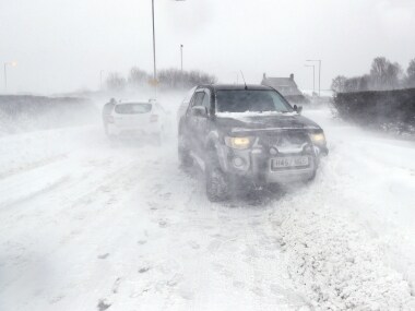 Cars in snowy conditions on the A192 road near Blyth, north east England, Thursday March 1, 2018. Persistent snow and freezing conditions are causing delays in many parts of Britain, with roads and train service hit particularly hard. Emergency officials said many drivers had to be rescued from stranded vehicles. (Owen Humphreys/PA via AP)