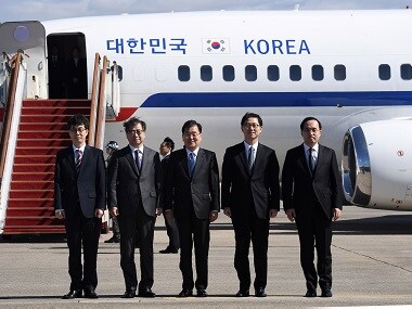 Members of South Korean delegation pose before boarding an aircraft as they leave for Pyongyang. Reuters