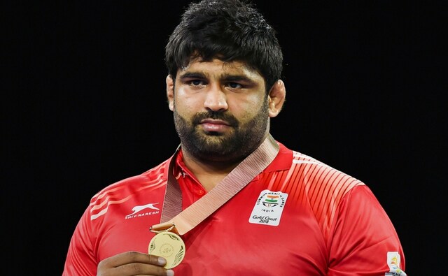Gold medalist India's Sumit during the medal ceremony of MFS 125kg wrestling Nordic at the Commonwealth Games 2018. He won the final bout without a fight at all, as his opponent gave a walkover due to injury. PTI Gold medalist India's Sumit during the medal ceremony of MFS 125kg wrestling Nordic at the Commonwealth Games 2018. He won the final bout without a fight at all, as his opponent gave a walkover due to injury. PTI