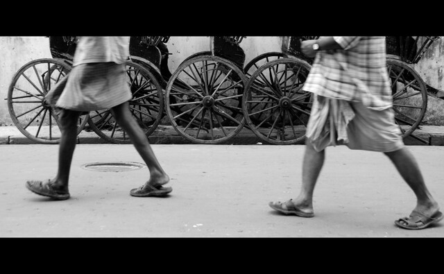 Traversing Kolkata’s streets — especially in the northern part of the city — can pose quite the challenge: the narrow lanes are littered with garbage and a slew of vehicles honk constantly. Amid the din, you’ll find a few (mostly) emaciated men, pulling their rickshaws behind them. Photo by Satwik Paul. Traversing Kolkata’s streets — especially in the northern part of the city — can pose quite the challenge: the narrow lanes are littered with garbage and a slew of vehicles honk constantly. Amid the din, you’ll find a few (mostly) emaciated men, pulling their rickshaws behind them. Photo by Satwik Paul.