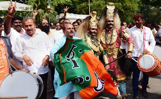BJP supporters with folk artists celebrate BS Yeddyurappa's swearing-in as the chief minister outside Raj Bhavan in Bengaluru on Thursday. Celebrations also broke out at the party's office in the city's northwest suburb and many districts across Karnataka. PTI BJP supporters with folk artists celebrate BS Yeddyurappa's swearing-in as the chief minister outside Raj Bhavan in Bengaluru on Thursday. Celebrations also broke out at the party's office in the city's northwest suburb and many districts across Karnataka. PTI