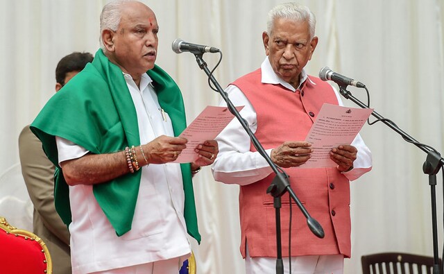 Karnataka Governor Vajubhai Vala administers oath to Bharatiya Janata Party (BJP) leader BS Yeddyurappa as chief minister of the state at a ceremony in Bengaluru on Thursday. The BJP leader was invited by the governor on Wednesday to take oath as the chief minister and form the government. PTI Karnataka Governor Vajubhai Vala administers oath to Bharatiya Janata Party (BJP) leader BS Yeddyurappa as chief minister of the state at a ceremony in Bengaluru on Thursday. The BJP leader was invited by the governor on Wednesday to take oath as the chief minister and form the government. PTI