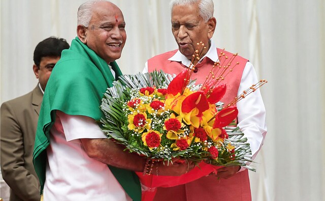 Karnataka Governor Vajubhai Vala greets newly sworn-in Chief Minister of Karnataka BS Yeddyurappa. BJP leader Sadanand Gowda described the event as an end of dictatorship as Yeddyurappa took oath as the 23rd chief minister of the state. PTI Karnataka Governor Vajubhai Vala greets newly sworn-in Chief Minister of Karnataka BS Yeddyurappa. BJP leader Sadanand Gowda described the event as an end of dictatorship as Yeddyurappa took oath as the 23rd chief minister of the state. PTI