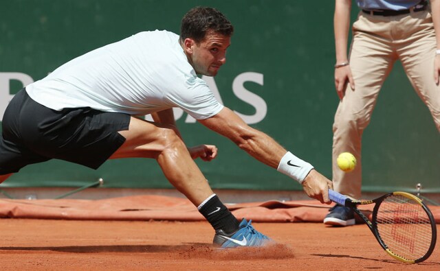 Grigor Dimitrov of Bulgaria stretches to return the ball to Jared Donaldson on Day 4. AP Grigor Dimitrov of Bulgaria stretches to return the ball to Jared Donaldson on Day 4. AP