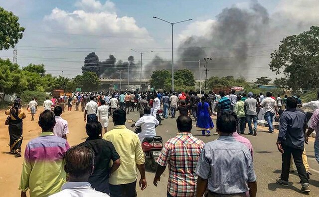 Smoke billows out of burning vehicles after a protest demanding closure of Vedanta's Sterlite Copper unit in Tuticorin turned violent on Tuesday. PTI Smoke billows out of burning vehicles after a protest demanding closure of Vedanta's Sterlite Copper unit in Tuticorin turned violent on Tuesday. PTI